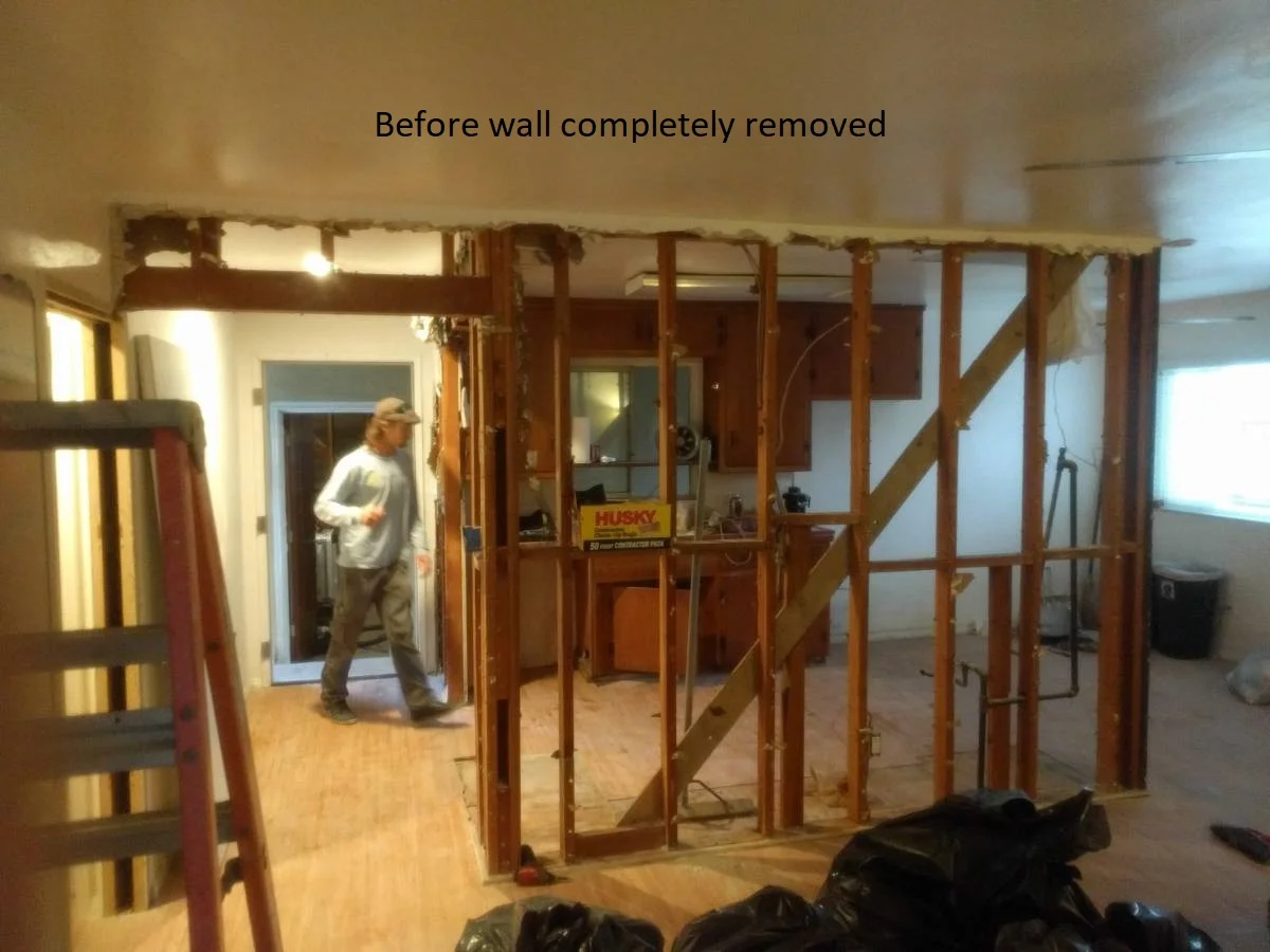 A newly remodeled modern kitchen in Austin featuring white shaker cabinets, dark concrete-style countertops on a large island, and stainless steel appliances, as part of the New Project in West Lake Hills, Dripping Springs, and the Texas Hill Country. - Detail 2