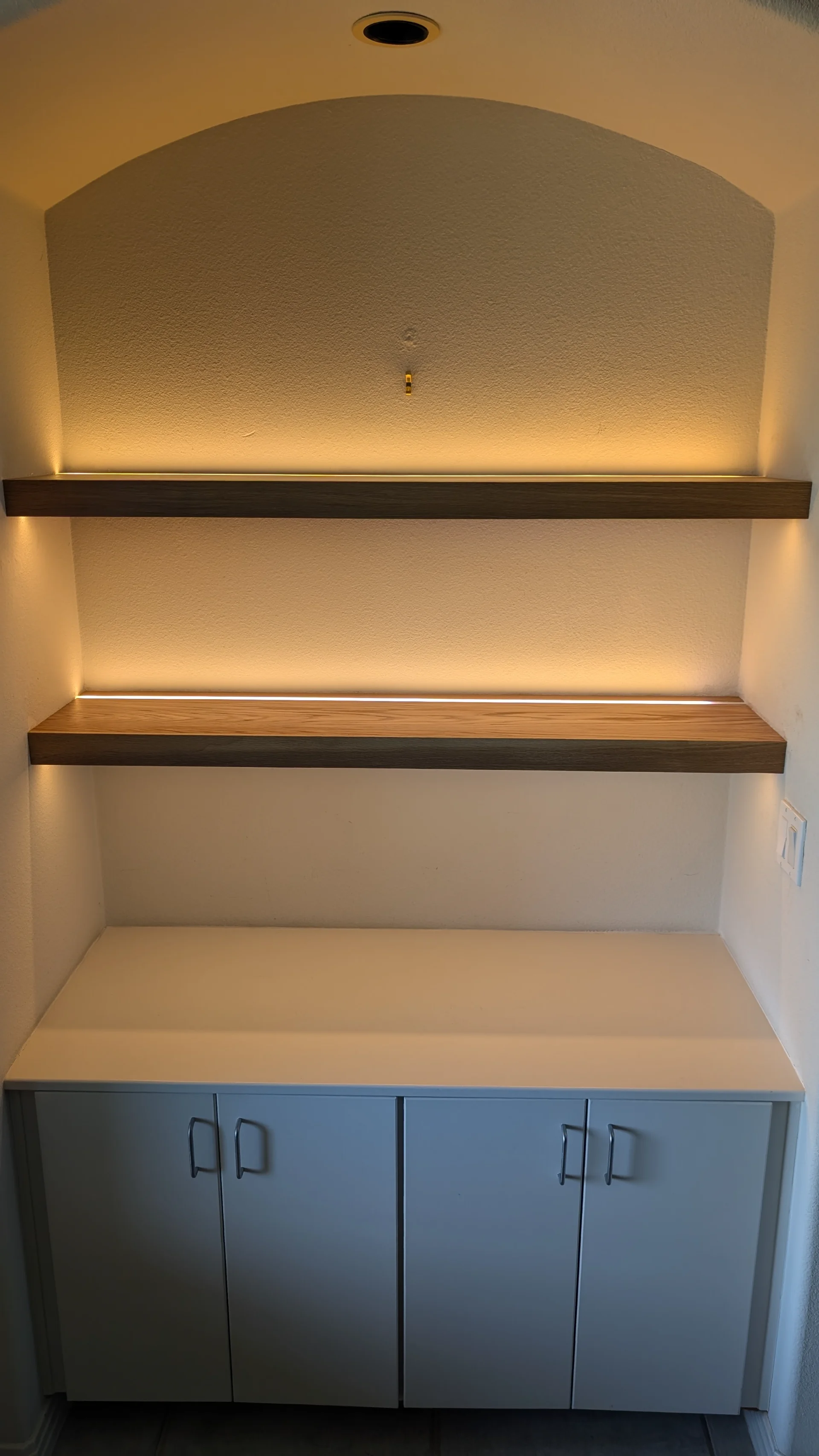 A modern residential staircase with light wood treads and white risers, featuring a contemporary railing with black metal balusters and a light wood handrail, perfectly suited for a home in Austin or West Lake Hills. - Detail 2