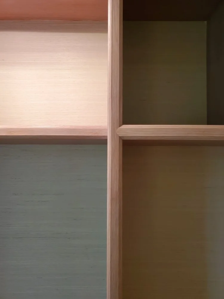 Custom light wood built-in entertainment center and shelving unit featuring integrated lighting, framed art, and decorative accents in a modern Austin home. - Detail 2