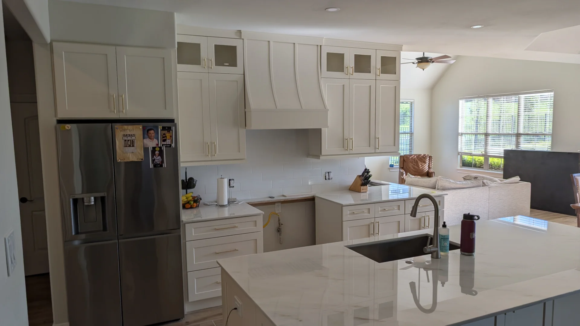 Shaker cabinetry and marble countertops in a Driftwood luxury kitchen project.