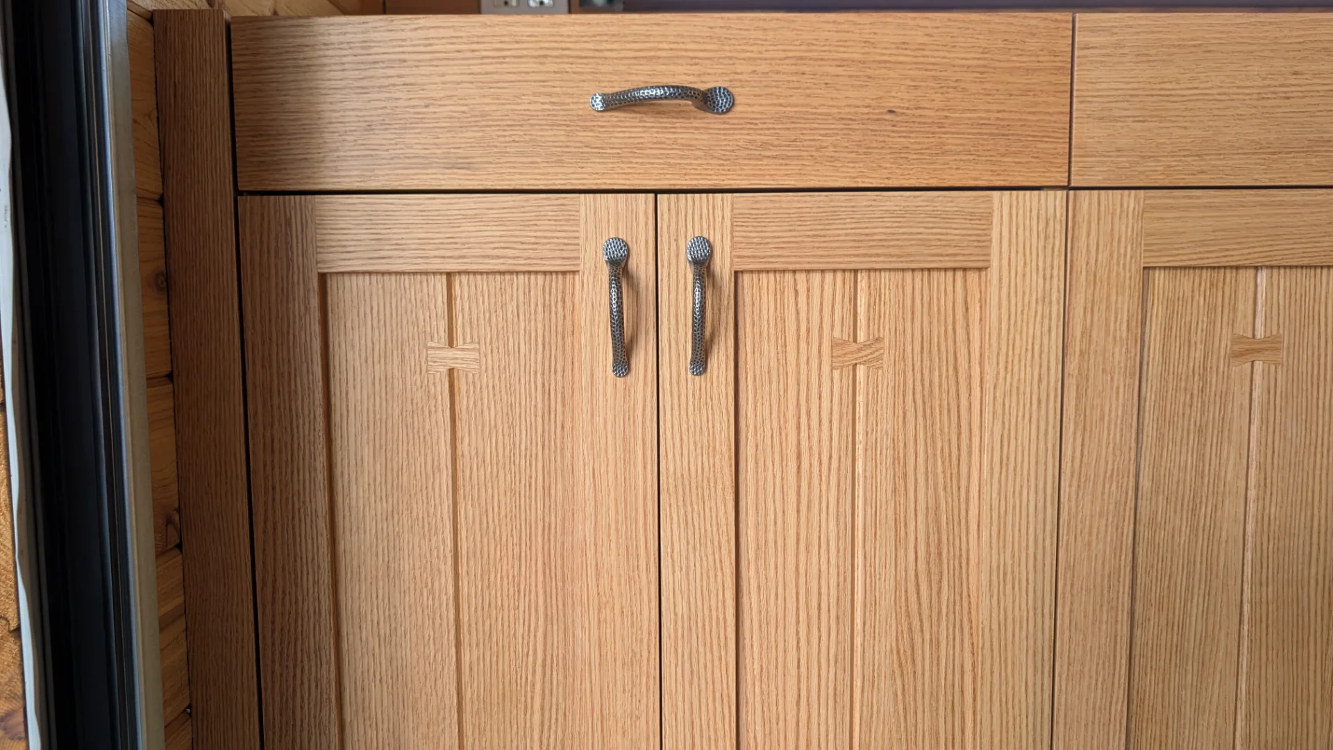 Custom rift sawn oak cabinetry featuring butterfly wood inlays in Hudson Bend - Austin, Texas.