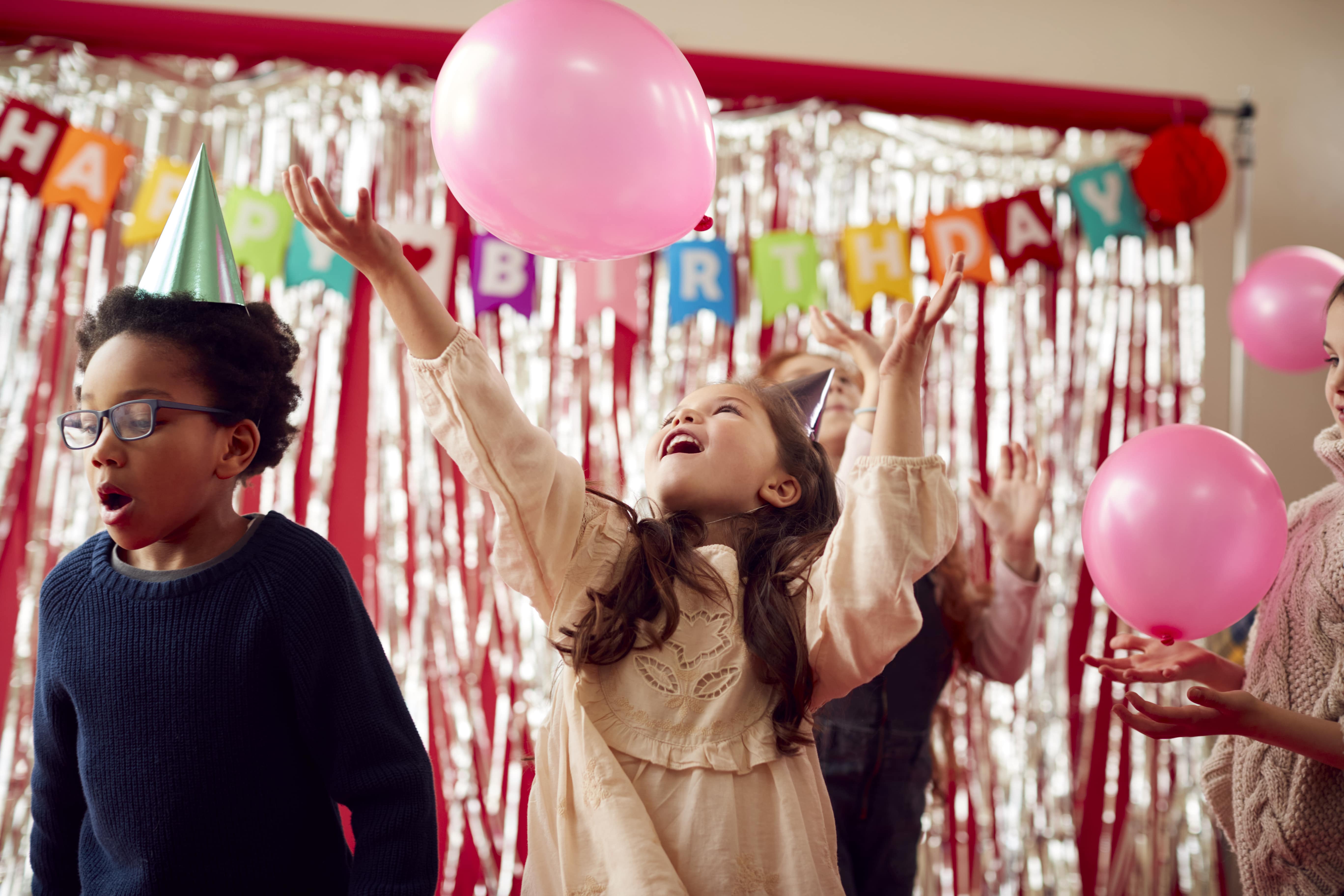 Young girls and boys celebrating with birtyhday hats on