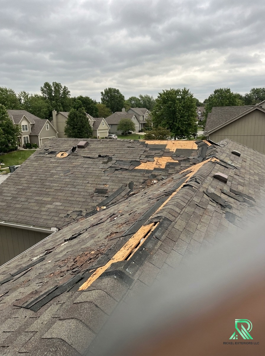 Kansas City residential roof showing storm damage and missing shingles before Rickel restoration