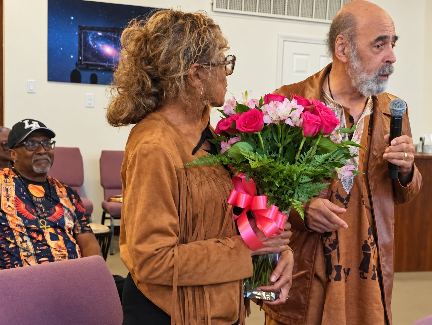 A member presented with a bouquet of roses