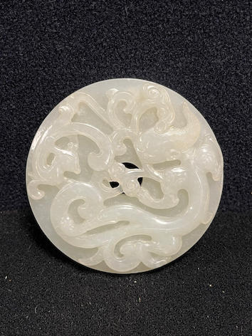 Qing white jade chilong bi disc — estimate: £3,000 – £5,000