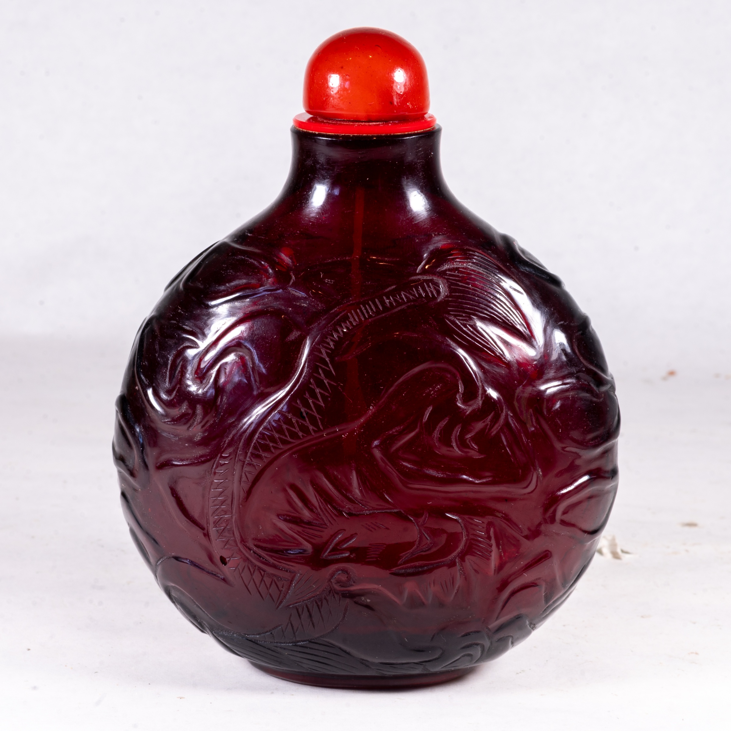 Chinese carved ruby-red 'Peking' glass snuff bottle, 19th century — estimate: £150 – £350