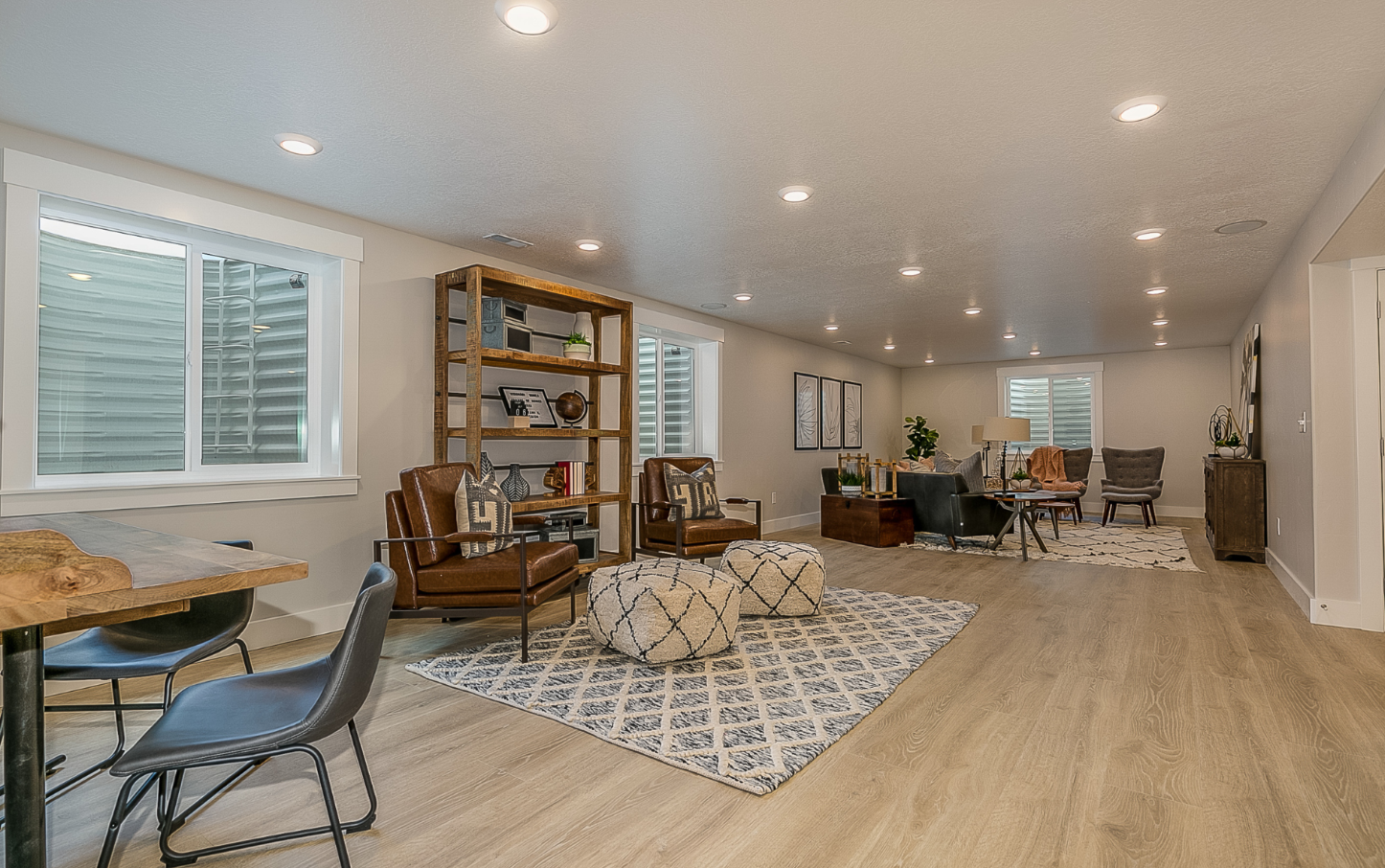 Finished basement with egress windows and window wells, recessed lighting and vinyl plank flooring