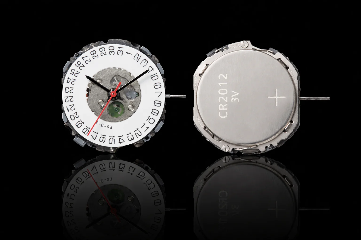 Front view of quartz watch movement with date wheel & hands. Back view with CR2012 battery. Reflective black surface.