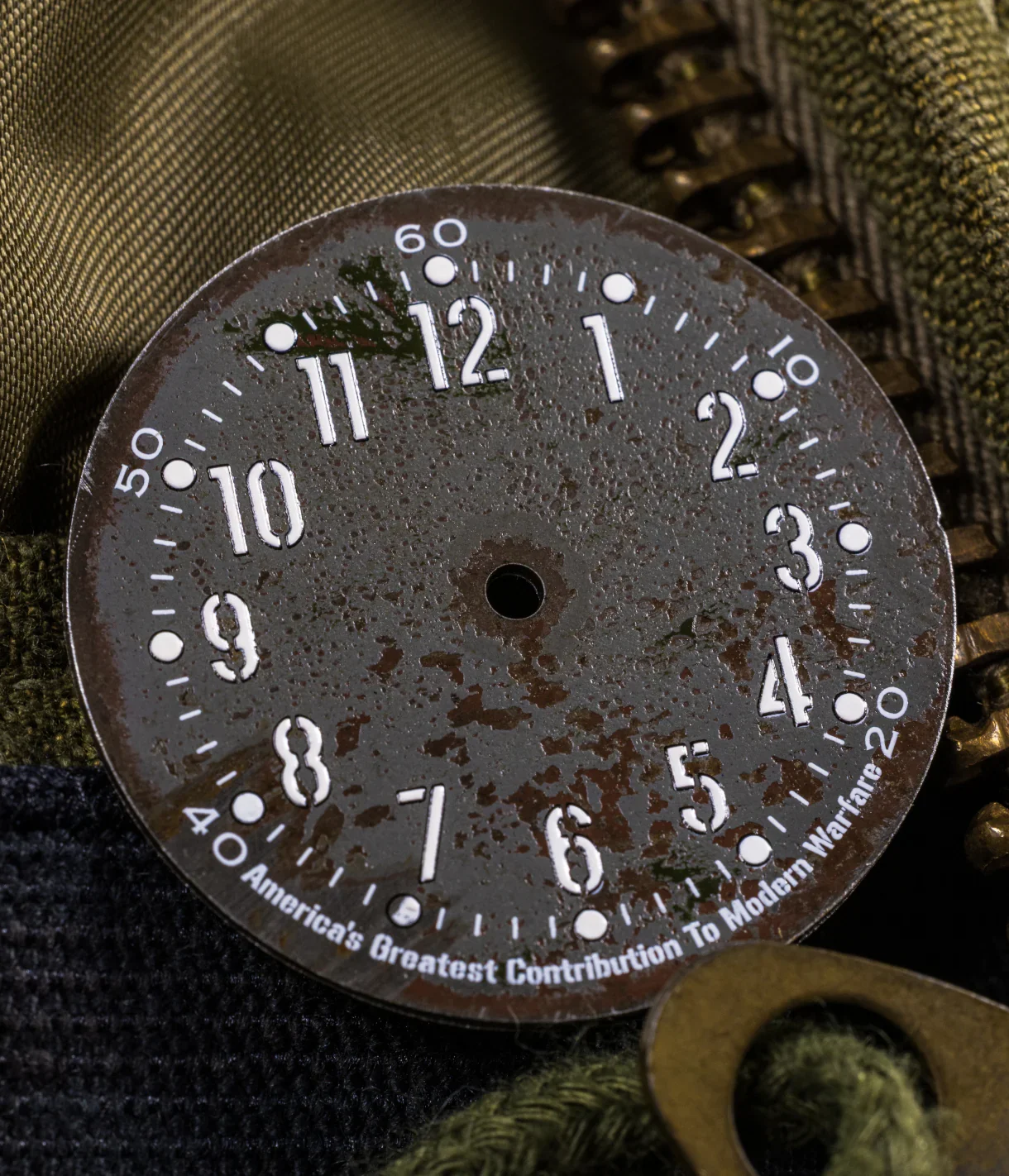 Distressed, dark watch dial with white numerals and