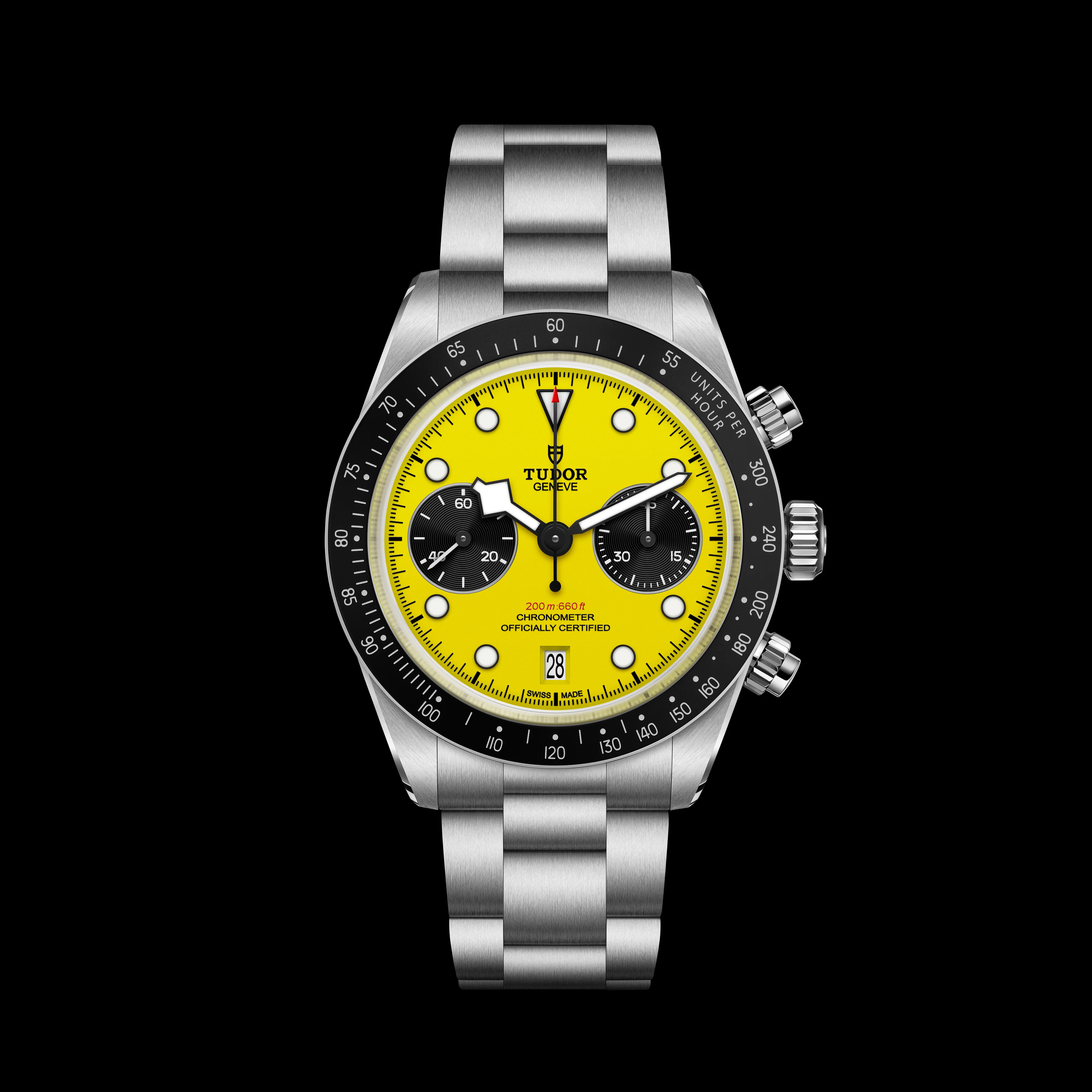Brushed steel Tudor watch with a bright yellow chronograph dial, black bezel, and date window on black.