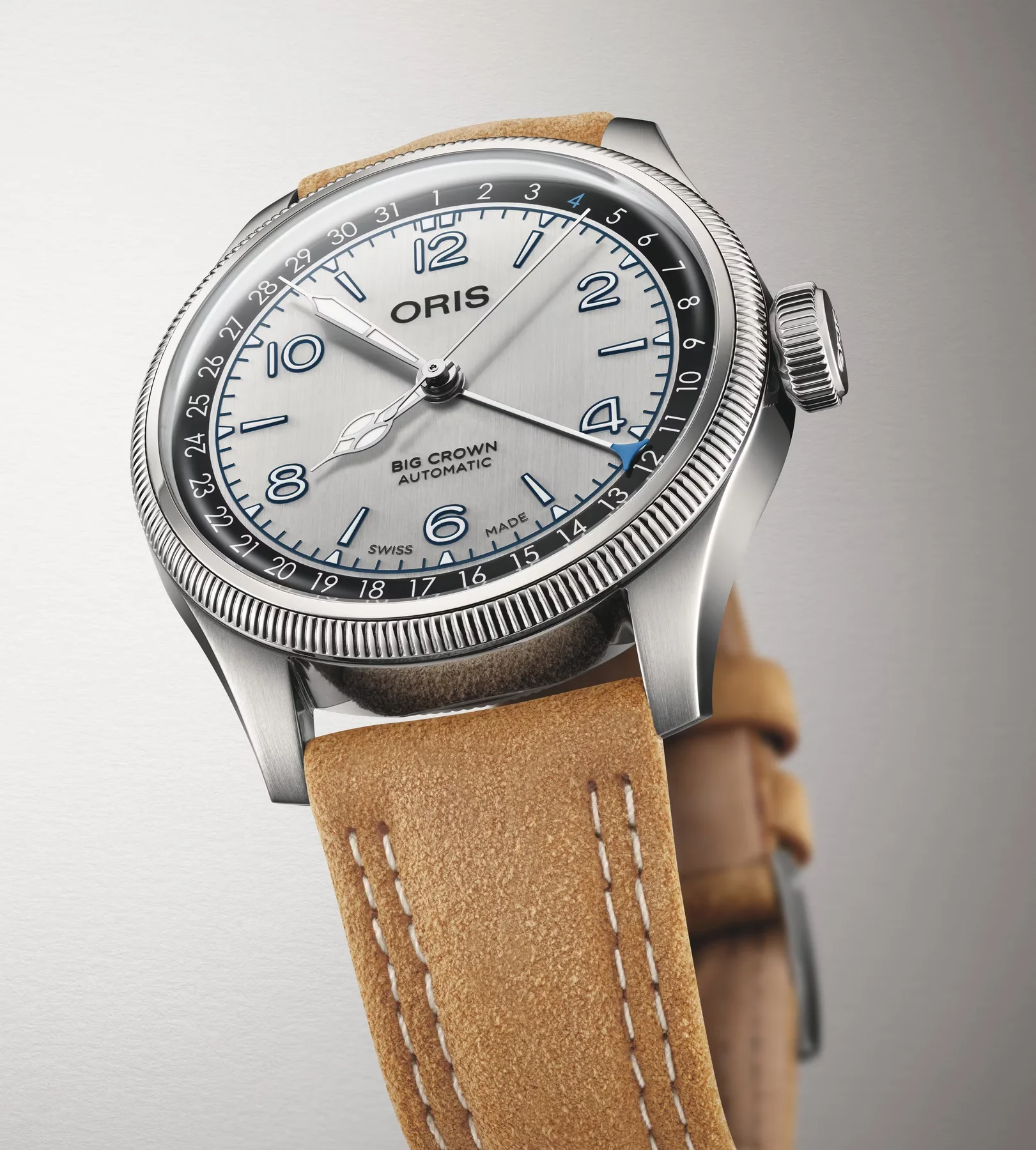 Oris Big Crown Automatic watch with silver dial, blue numerals, pointer date, fluted bezel, and tan suede strap.