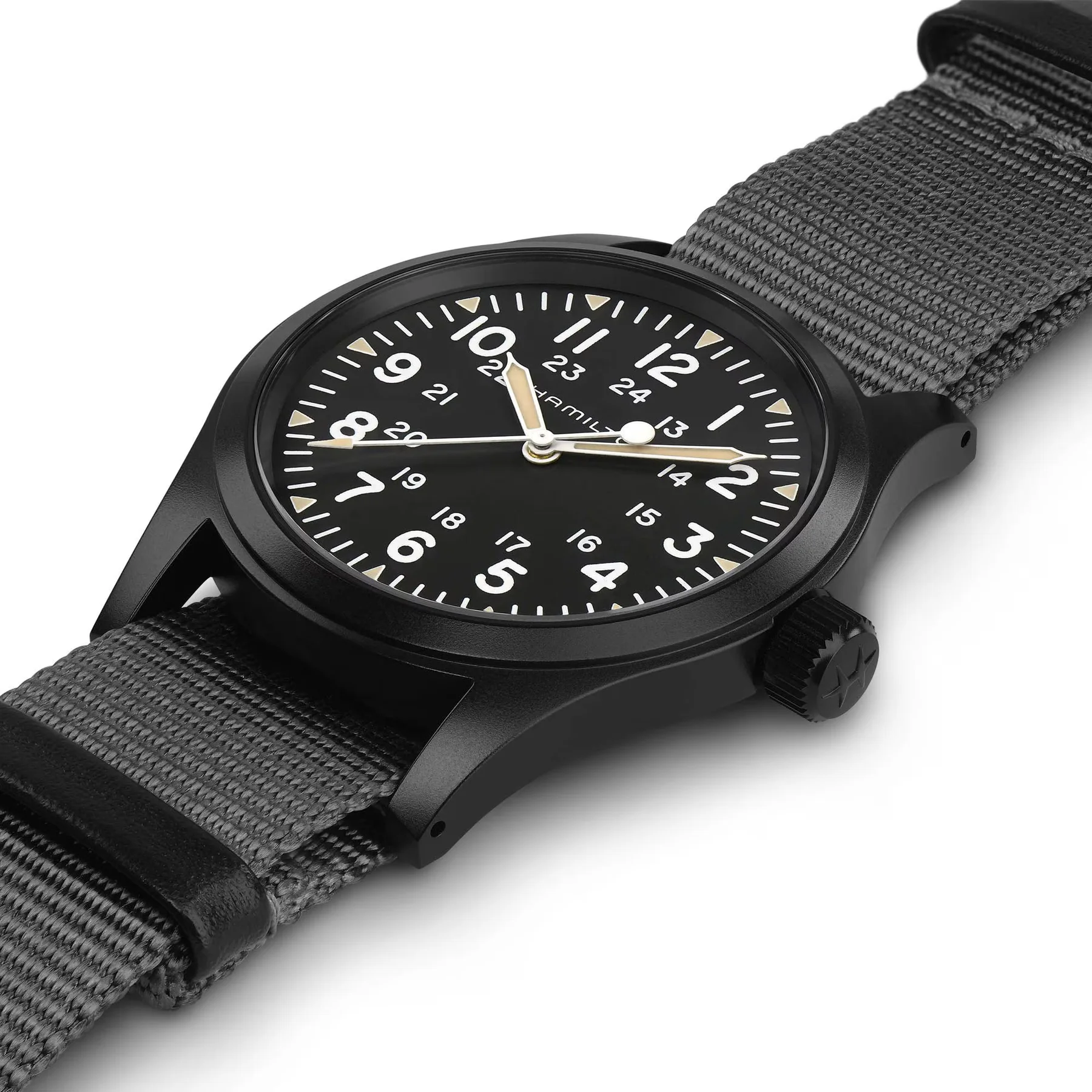 Black Hamilton field watch with a black dial, white numerals, tan hands, and a gray NATO strap, angled on white.