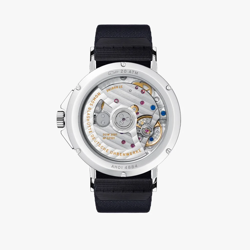 Nomos Ahoi Neomatik watch exhibition case back with intricate mechanical movement, rubies, and black strap.