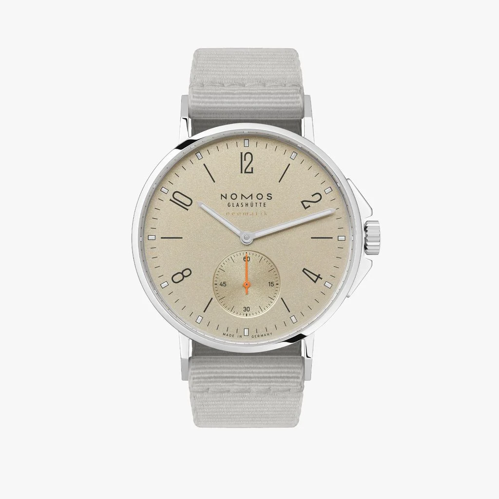 Nomos Glashütte Ahoi Neomatik 36 with sand dial, polished steel case, light gray fabric strap & orange sub-seconds.