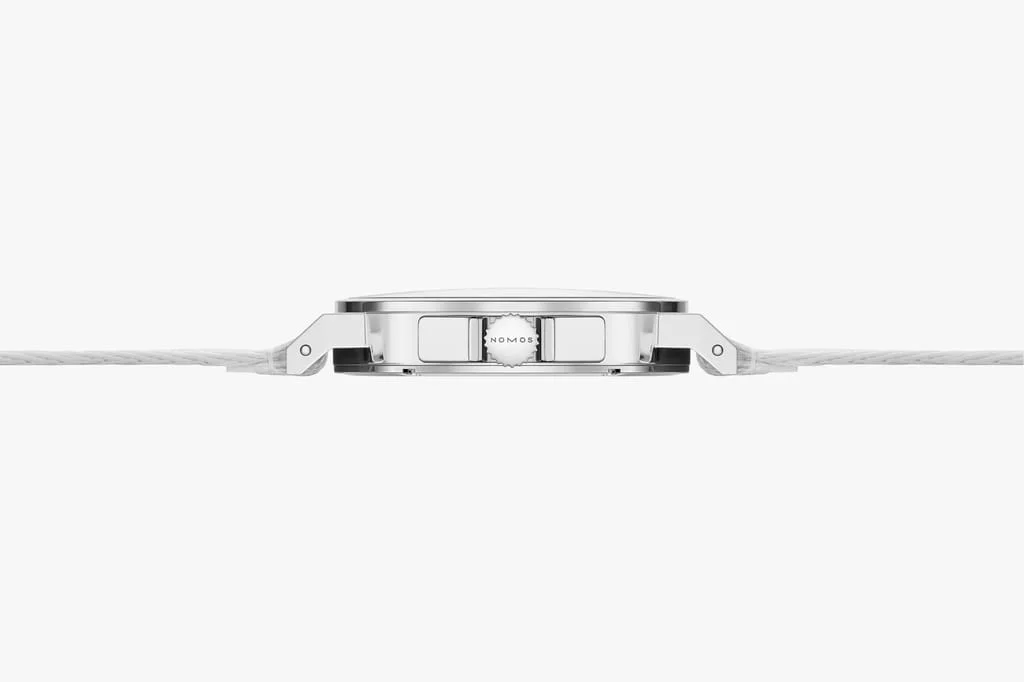 Side view of Nomos Ahoi Neomatik 36 watch with silver case, 'NOMOS' crown, and white textile strap.