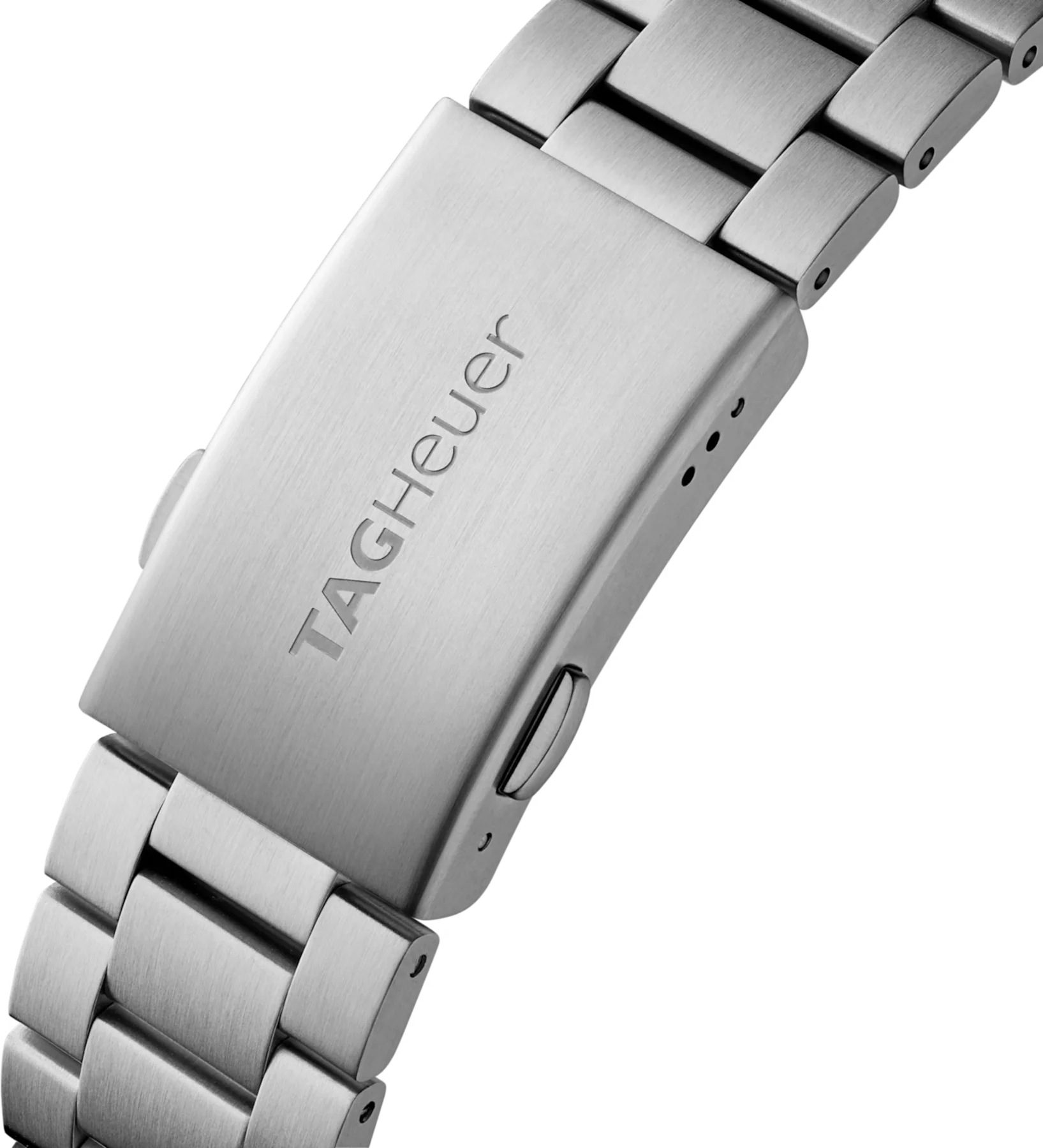 Close-up of a TAG Heuer stainless steel watch bracelet and its brushed clasp with engraved logo.