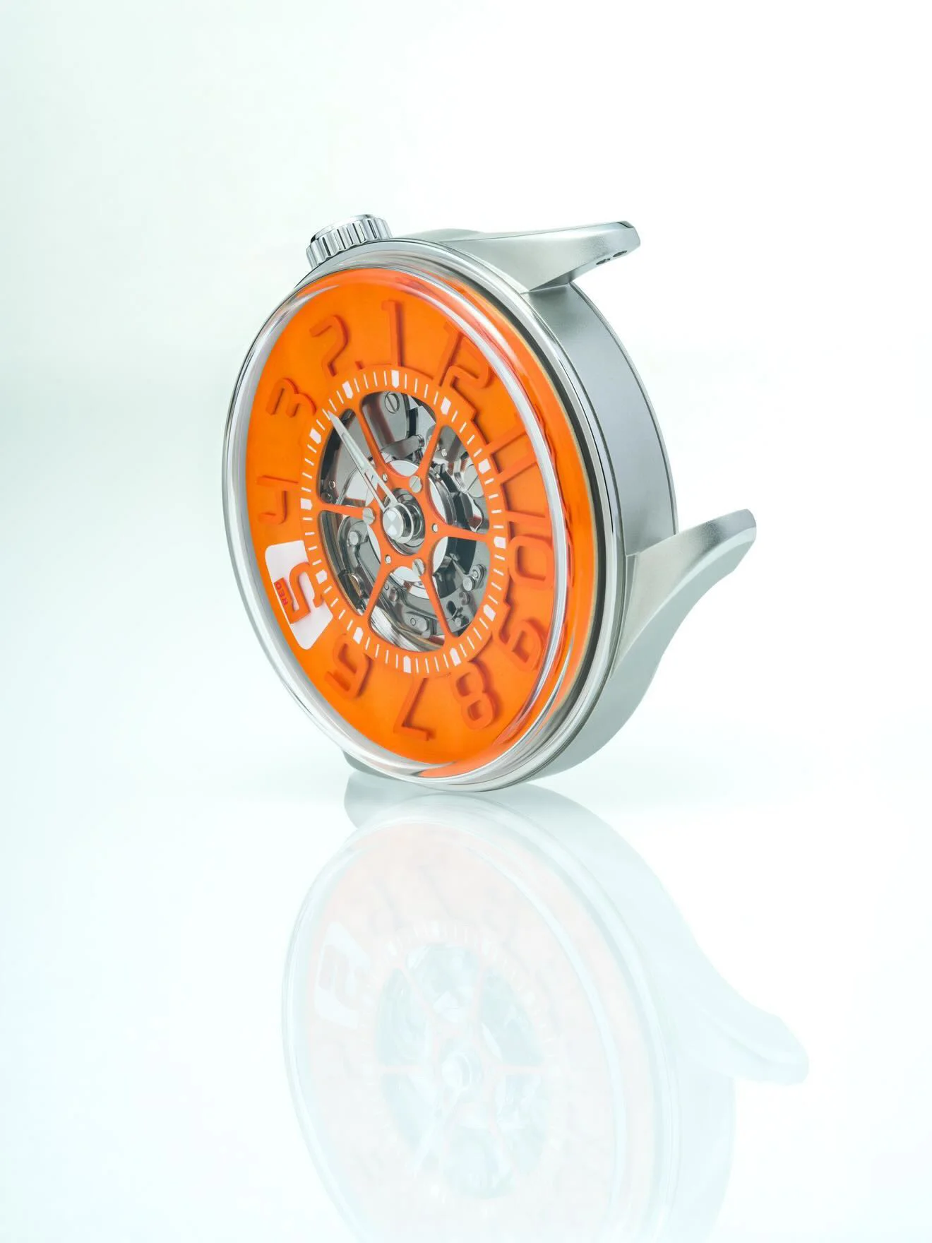 Sleek luxury watch with bright orange dial, visible mechanical movement, and silver case/lugs, on reflective white.