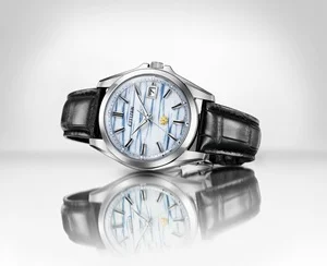 Silver Citizen watch with indigo washi paper dial, black leather strap, date window, reflected.