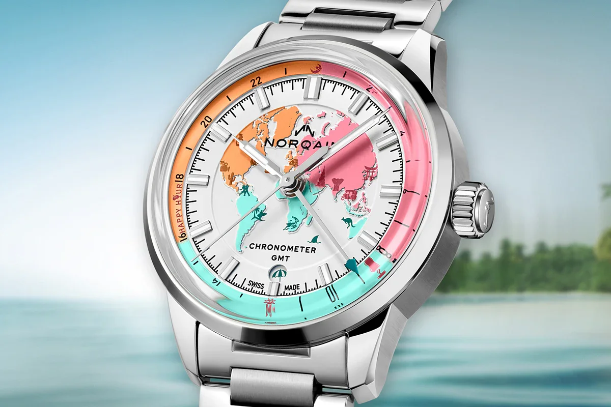 Silver Norqain watch with colorful world map dial, "Happy Hour" indicator, against a blurred tropical sky and water.