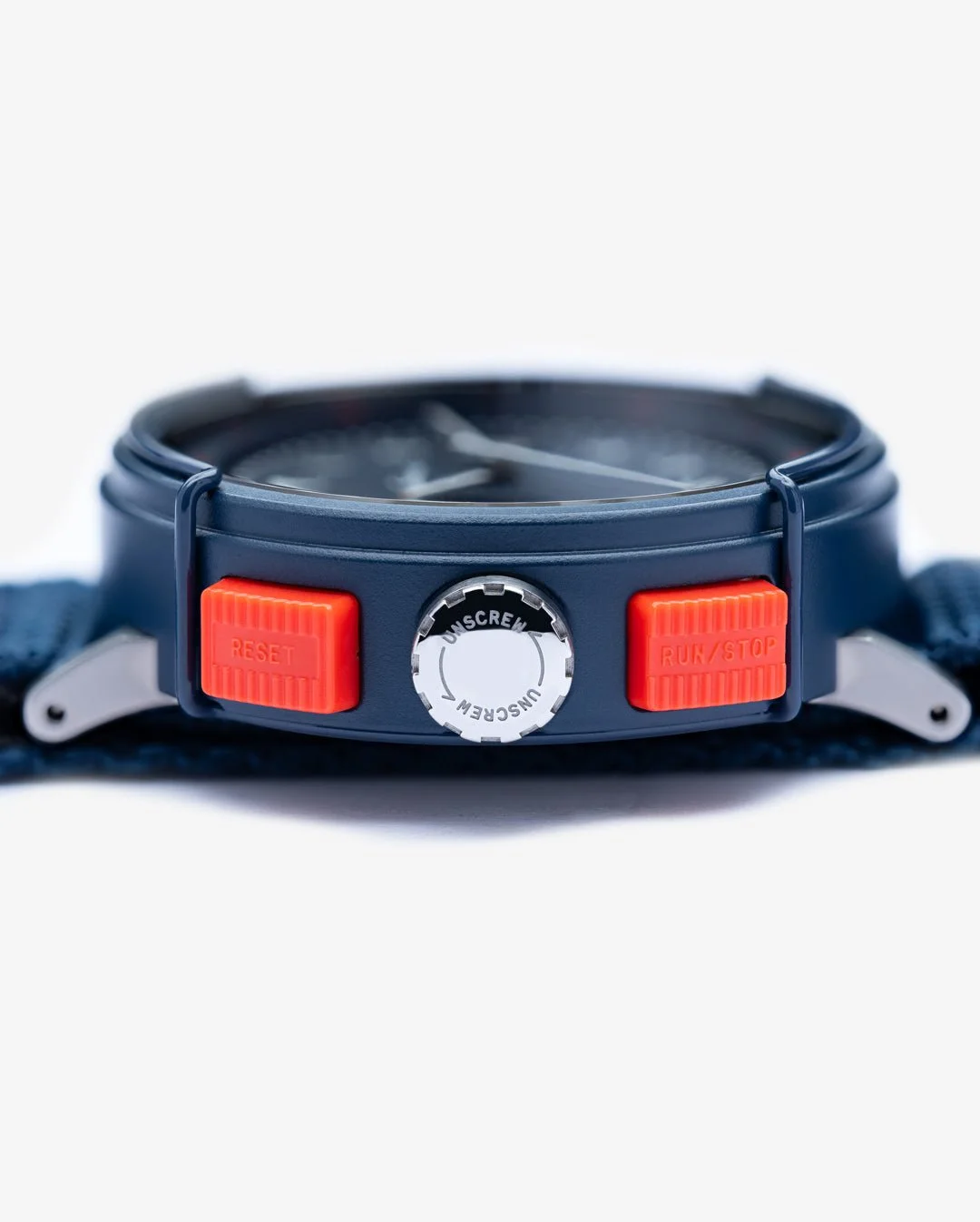Close-up of a blue watch showing orange 'RESET' and 'RUN/STOP' buttons, and a silver 'UNSCREW' crown.