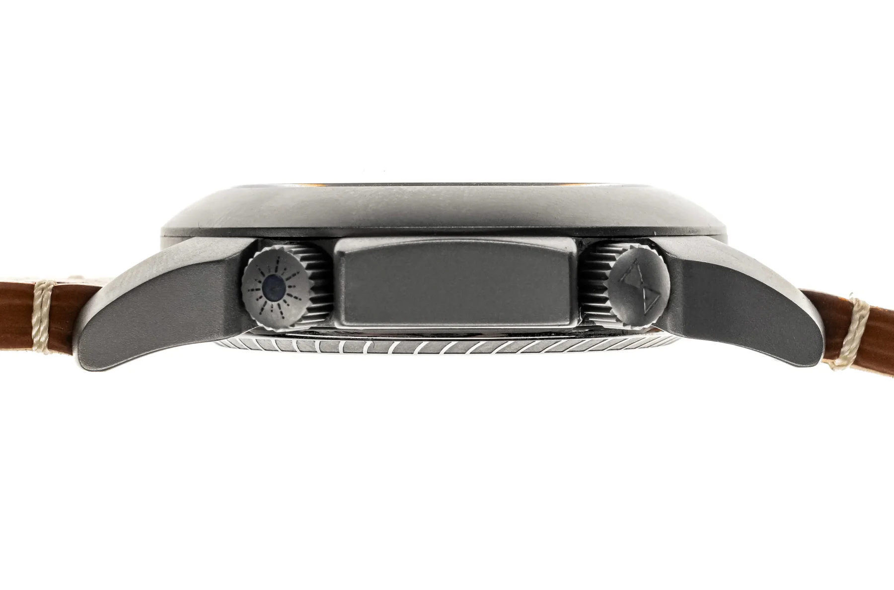 Side view of a dark gray watch case, fluted crowns (one with blue dot, one with logo), brown leather strap. White background.