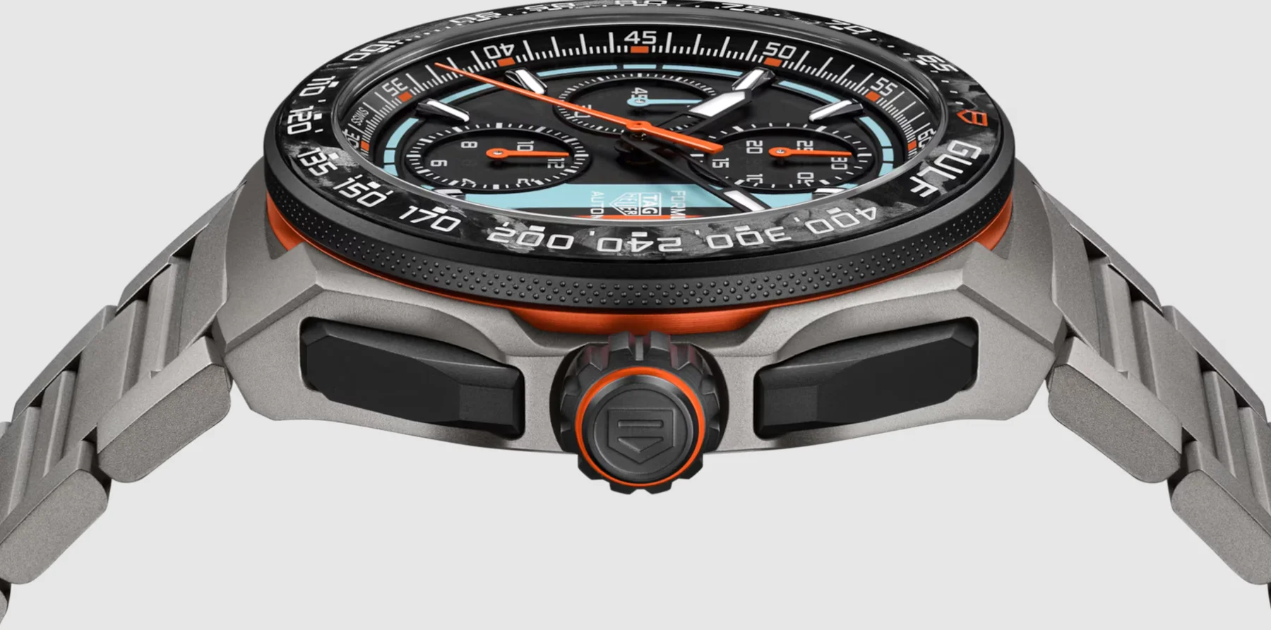Grey titanium TAG Heuer Gulf chronograph watch. Black dial, orange hands & highlights, light blue sub-dials, carbon fiber bezel.