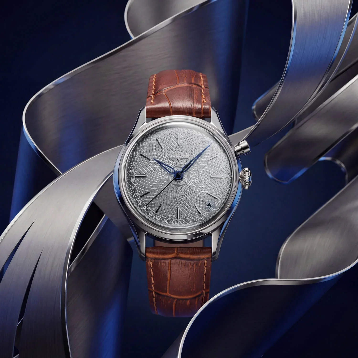 Silver watch with textured grey dial, blue hands, brown alligator strap, and sub-dials, amidst metal ribbons on blue.