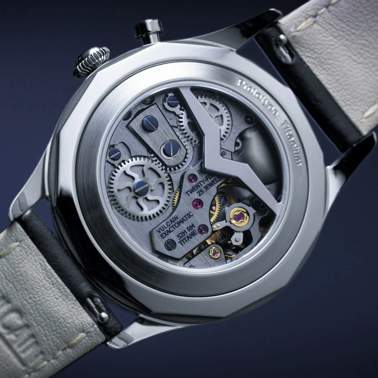 Close-up of a Vulcain Prototype Titanium watch's exhibition case back, showing intricate mechanical movement with gears and jewels.