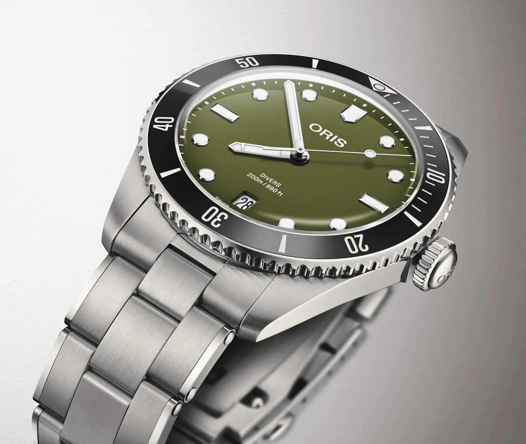 Oris Divers Date watch: olive green dial, black rotating bezel, luminous markers, stainless steel case & bracelet.