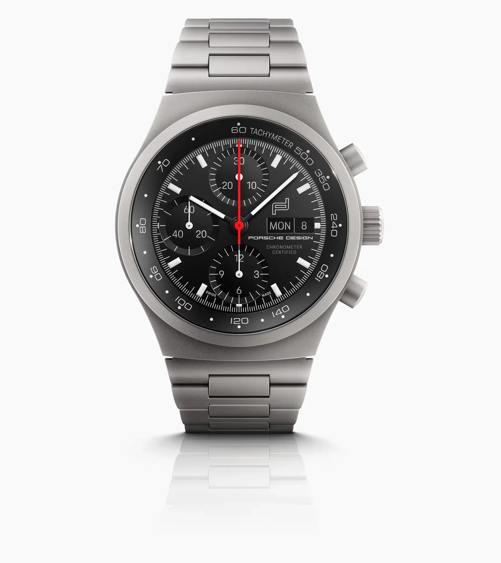 Porsche Design titanium chronograph watch with black dial, white hands, red chrono hand, day/date, on white background.