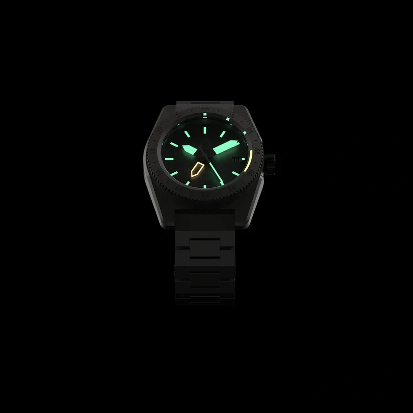 Black watch with glowing green hands, hour markers, yellow outlined shape, and date window against a black background.