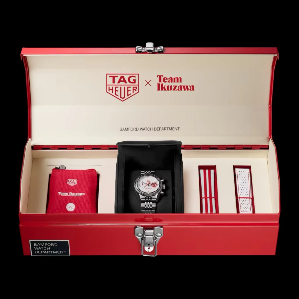 Open red TAG Heuer x Team Ikuzawa toolbox. Silver Carrera watch with white dial, red pouch, red-striped & white-dotted straps.