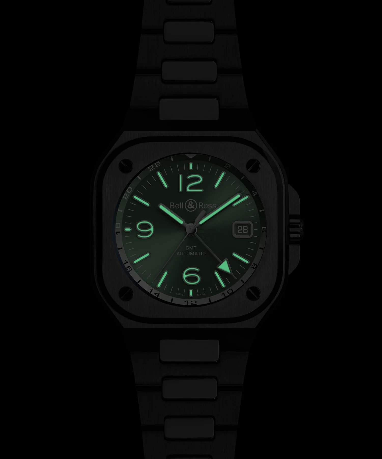 Dark Bell & Ross GMT Automatic watch with a square case and metal bracelet. Luminous green dial, hands, and markers glow brightly.