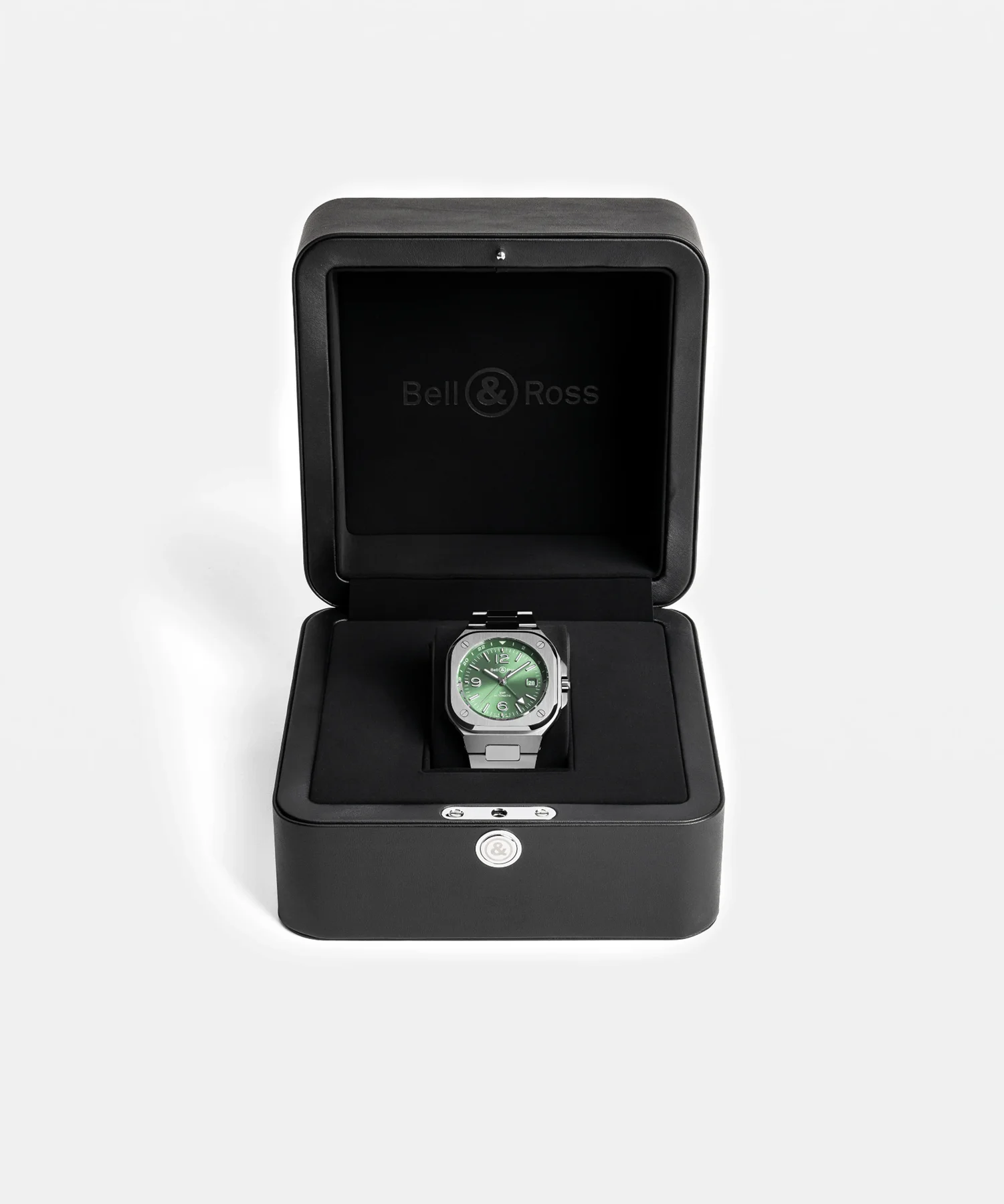 Bell & Ross BR 05 watch with green dial and steel bracelet in its open black luxury box on white.