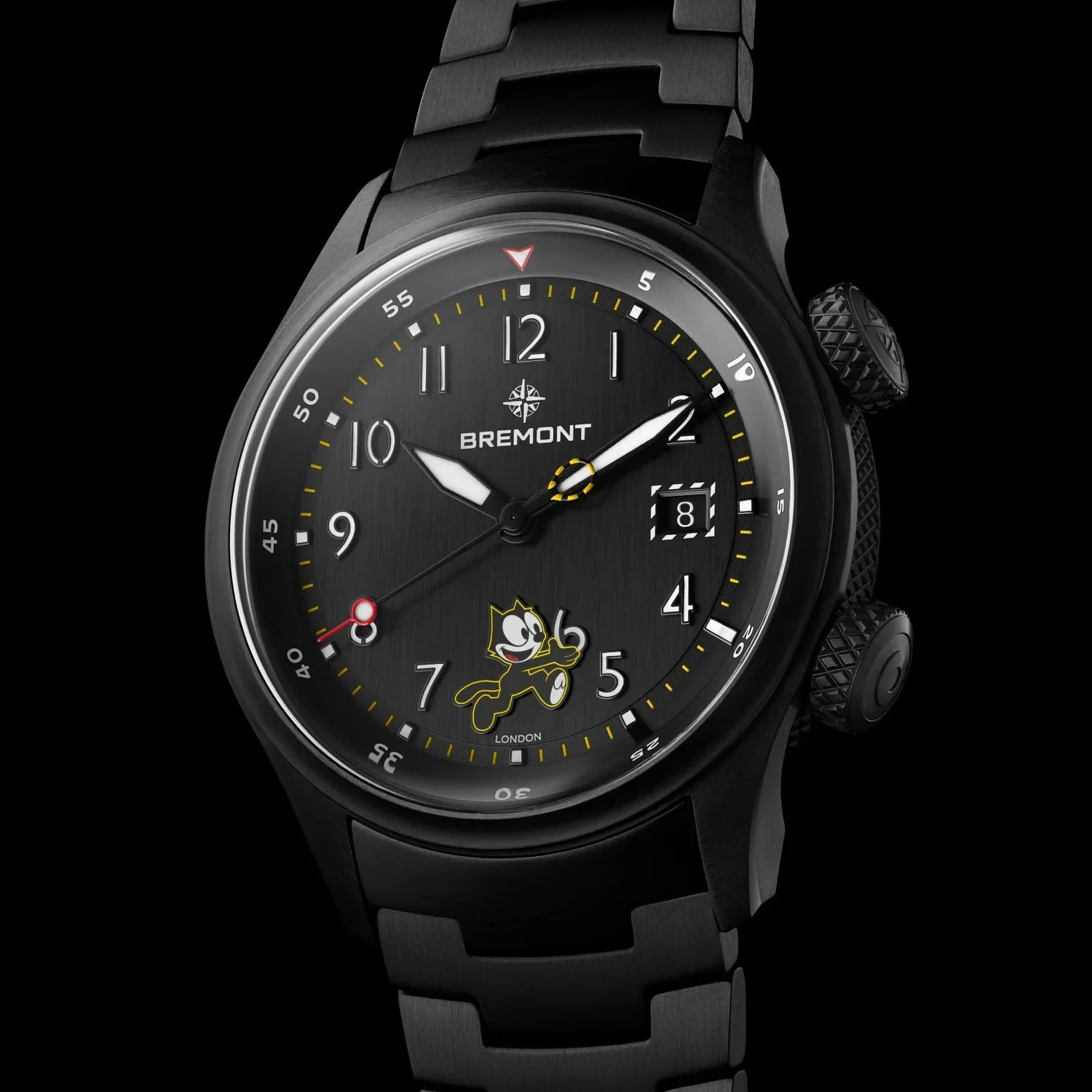 Close-up of an all-black Bremont watch with a running Felix the Cat on the dial, yellow markers, date, and textured crowns.