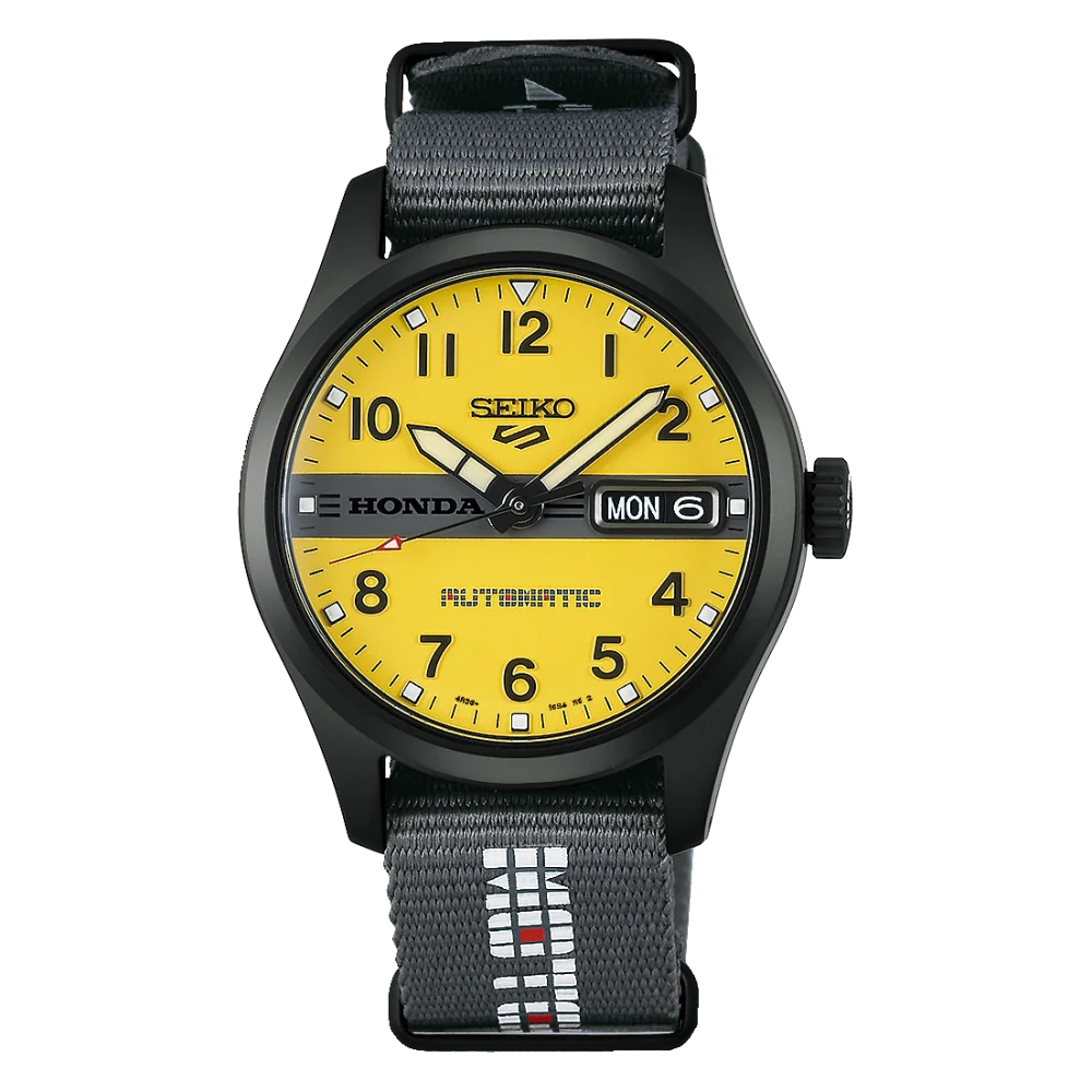 Seiko x Honda black-cased watch with bright yellow dial, day/date (MON 6), and black NATO strap.