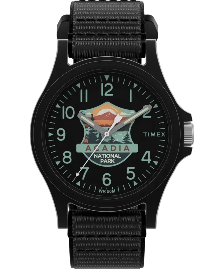 Black Timex watch with a black woven strap. Dial shows an Acadia National Park logo with mountains and trees.
