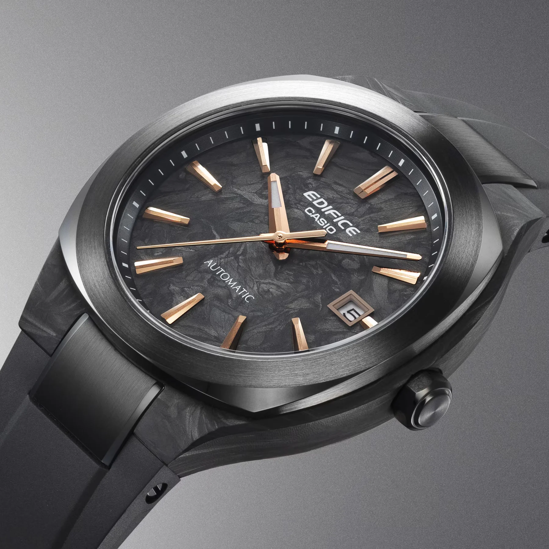 Edifice Casio automatic watch with dark forged carbon-pattern dial, gold markers, brushed dark case and strap. Date 5.