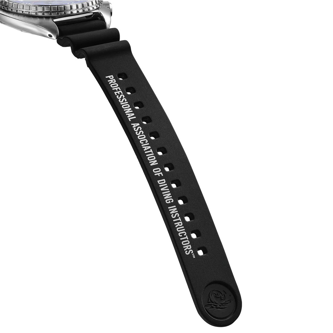 Close-up of a silver dive watch, blue bezel, black rubber strap reading 'PROFESSIONAL ASSOCIATION OF DIVING INSTRUCTORS'.