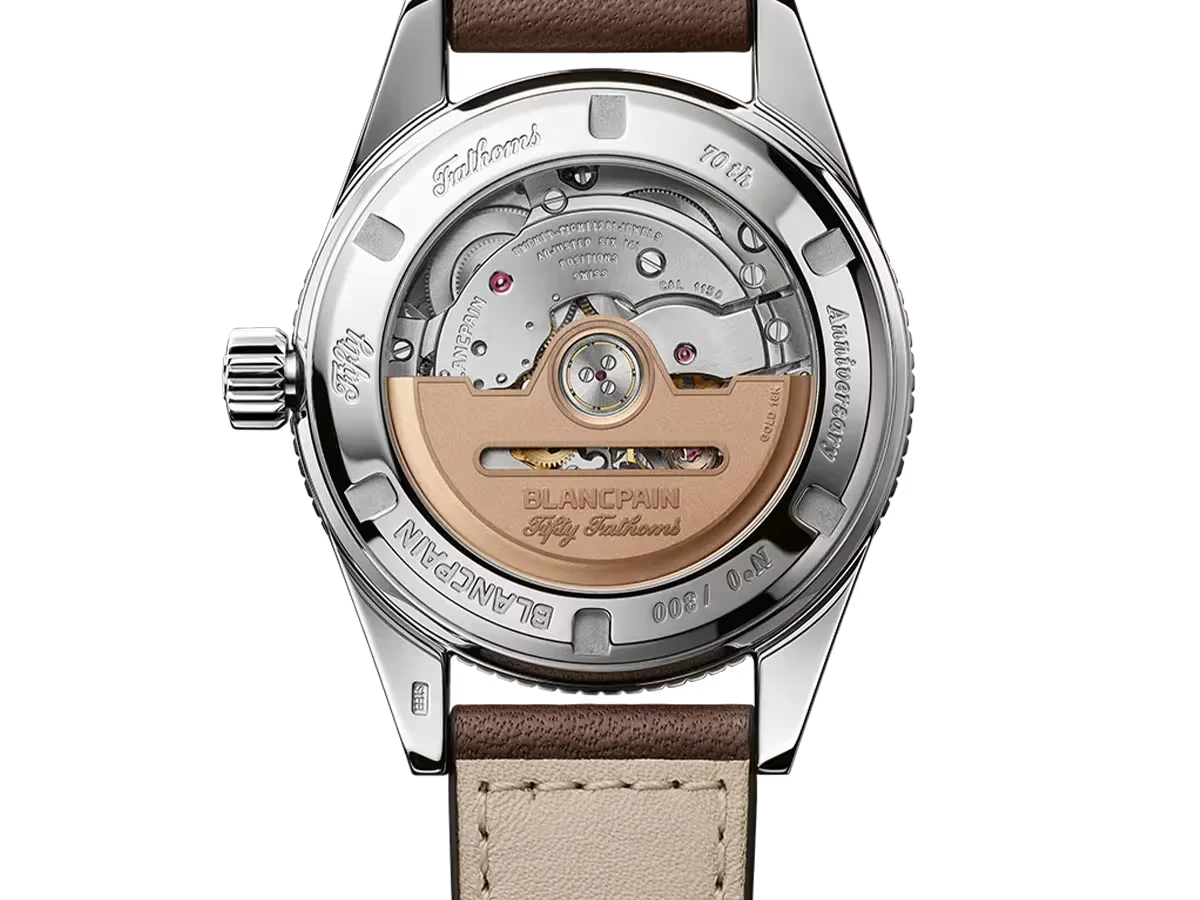 Blancpain Fifty Fathoms 70th Anniversary watch, exhibition caseback revealing automatic movement, rose gold rotor, steel case, brown strap.