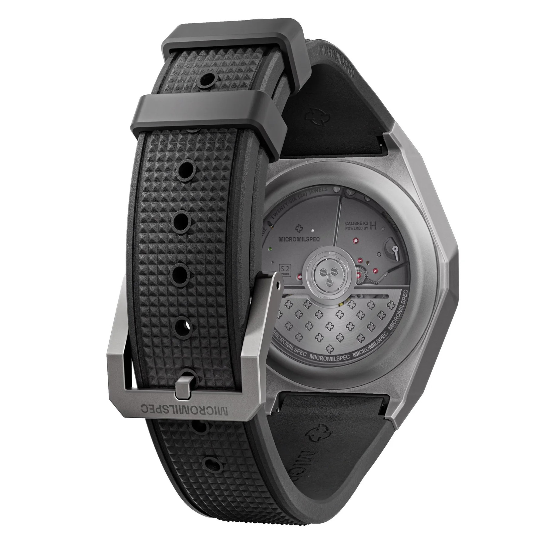 Black textured rubber watch strap and grey case. Rear view displays automatic movement through clear caseback, with 