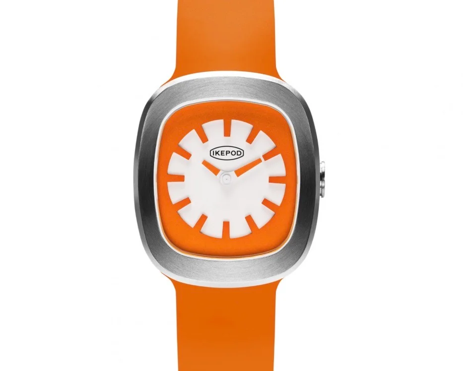 Ikepod luxury watch: orange rubber strap, cushion-shaped silver case, white dial with orange hour markers.