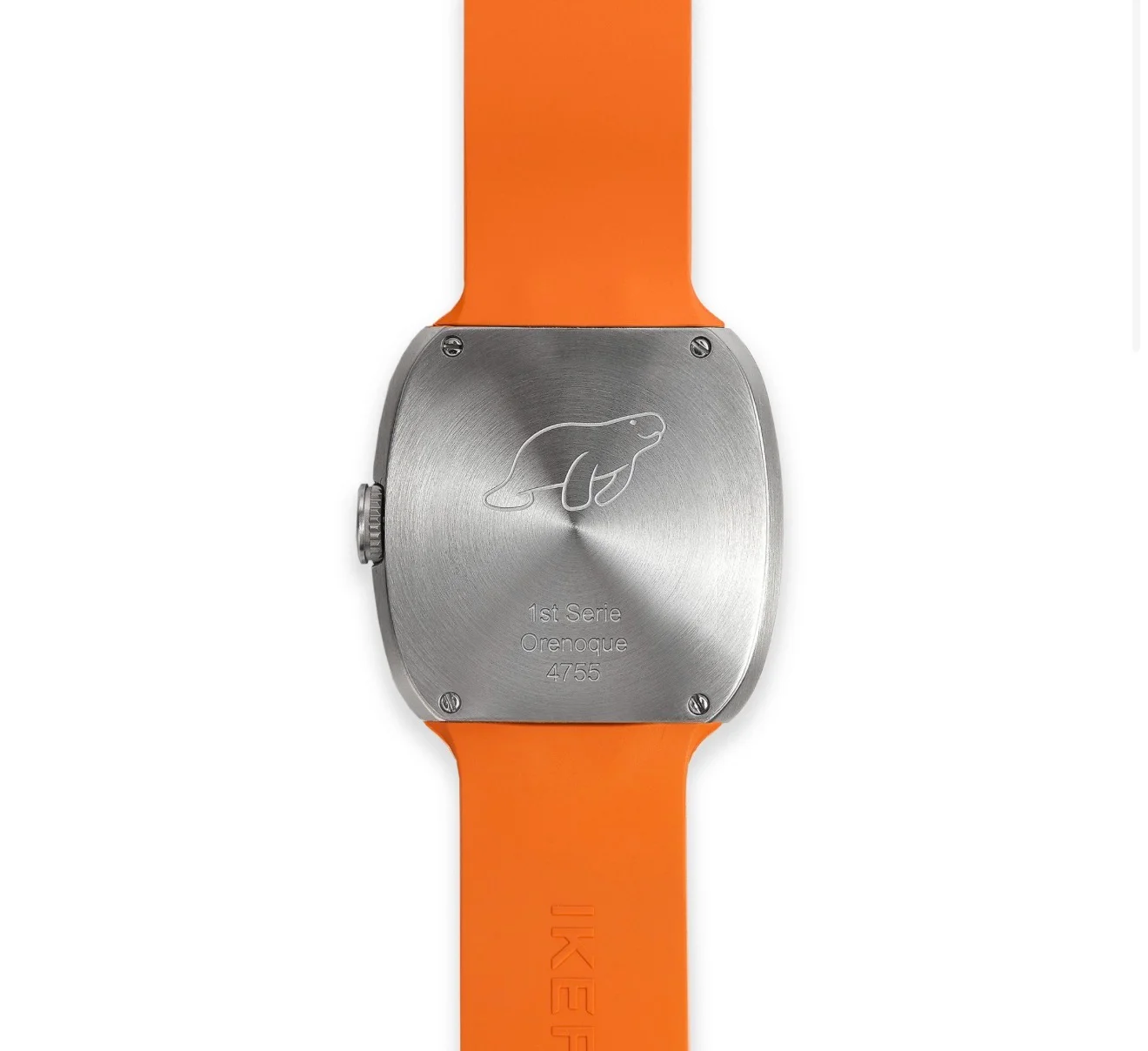 Brushed metal watch case back with engraved sea otter, '1st Serie Orenoque 4755', and orange IKEA strap.