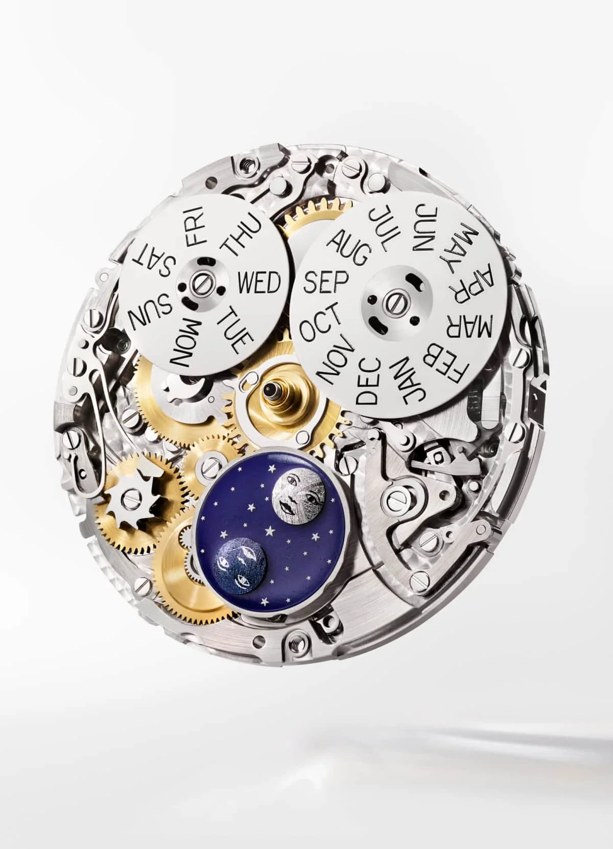Complex watch movement with gold gears, day & month wheels, and a blue moon phase disc showing two moons with faces.
