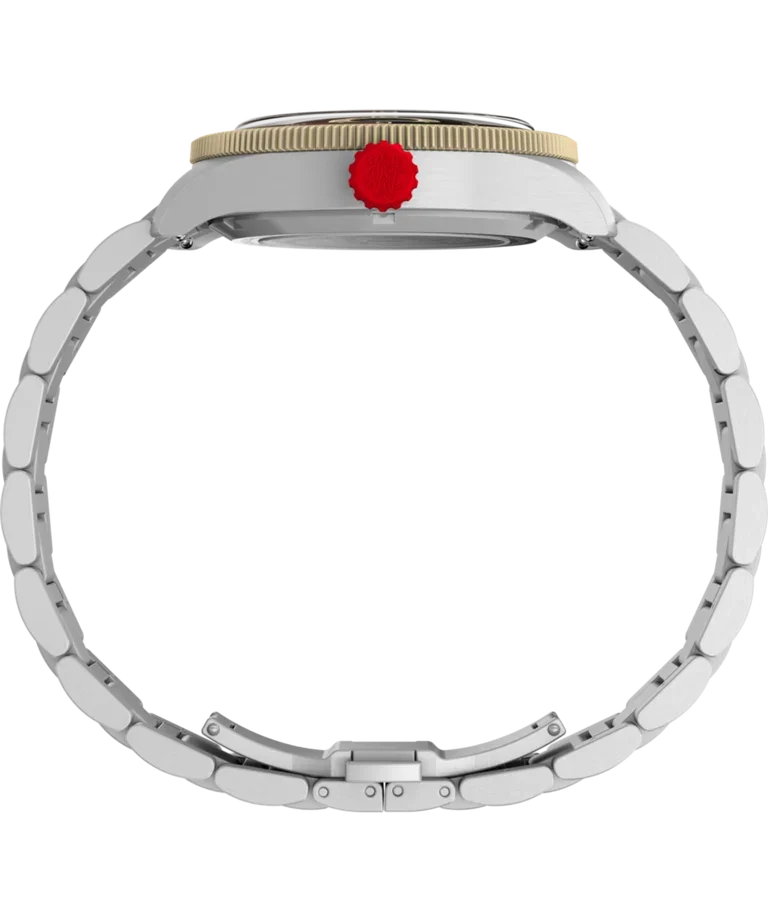 Side view of a silver watch with gold fluted bezel, red crown, and circular metal bracelet on black.