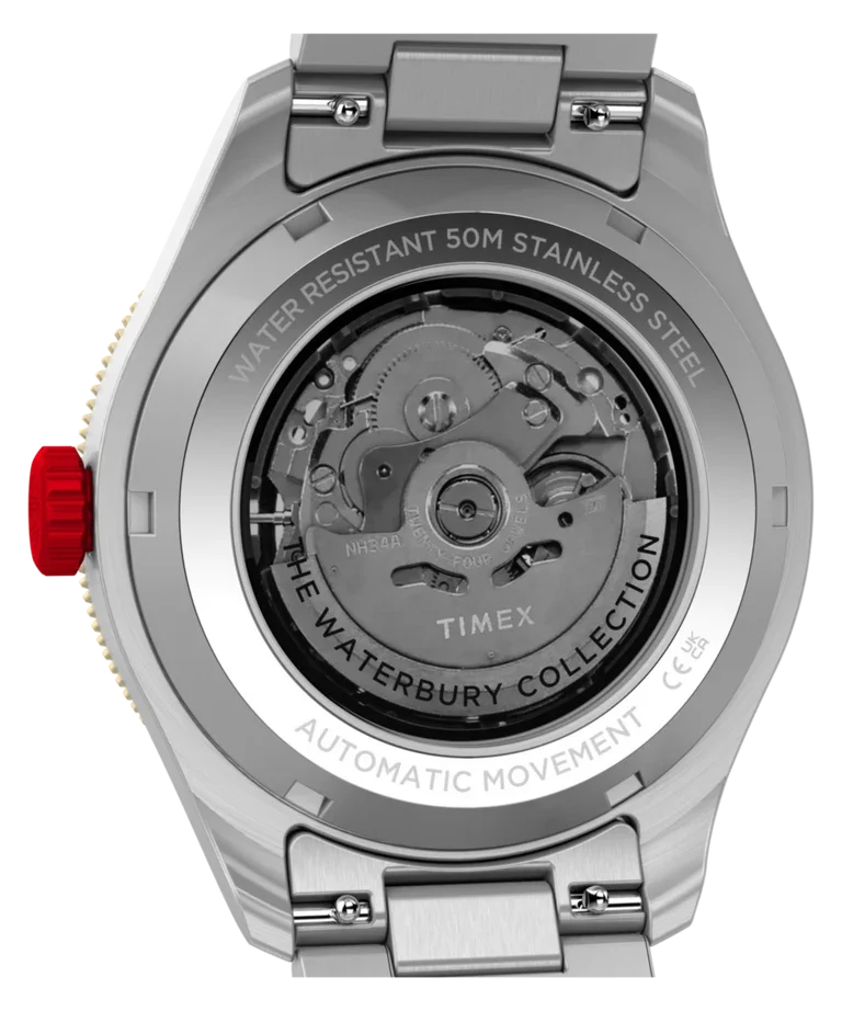 Back of a Timex Waterbury Collection automatic watch. Open caseback reveals mechanical movement, engraved text, and red crown.