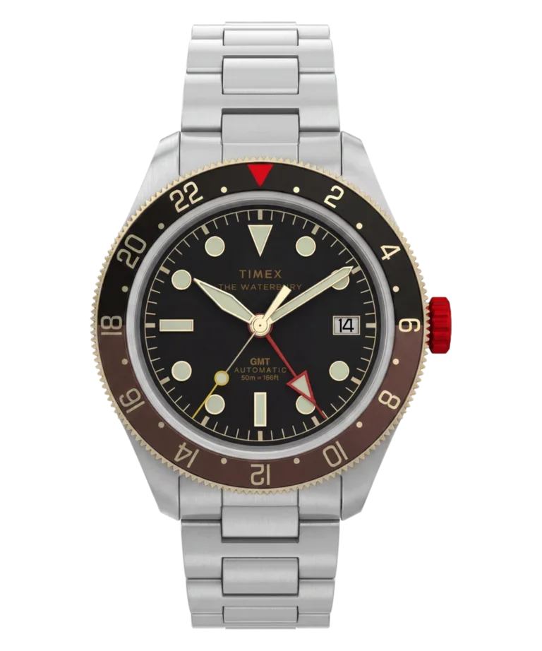 Timex Waterbury GMT automatic watch with black dial, steel bracelet, and black/brown 24-hour bezel, red crown.