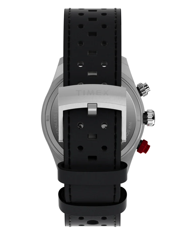 Rear view of a Timex watch with a black perforated racing strap, silver buckle, and red pusher.