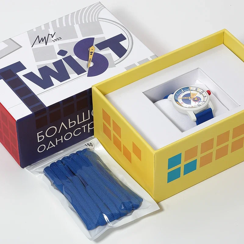 Colorful, white-cased watch with blue strap in yellow box. Twist outer box with Cyrillic text & packet of blue straps.