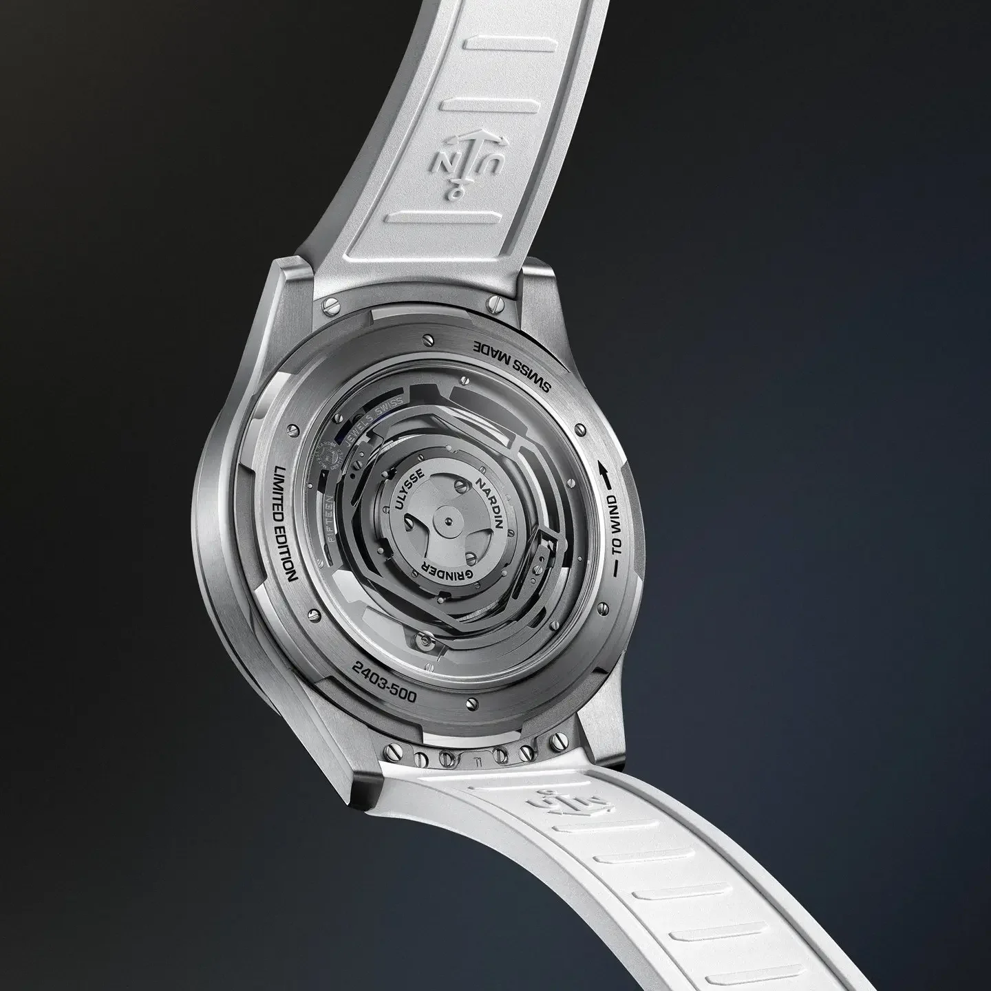 Ulysse Nardin watch, back view: brushed metal case, white rubber strap, exhibition caseback revealing automatic movement.